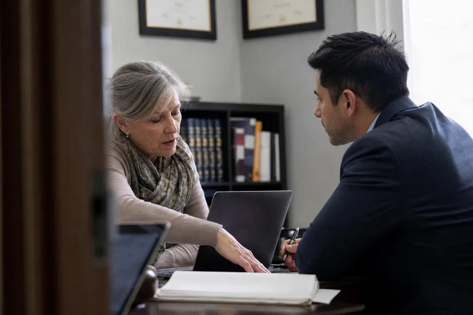 Two immigration law partners weighing a software switch at a conference table